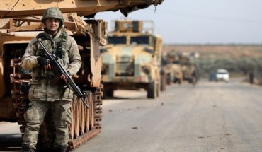 A Turkish soldier stands in front of a military vehicles convoy east of Idlib city in northwestern Syria on February 20, 2020 amid ongoing regime offensive on the last major rebel bastion in the country's northwest. 