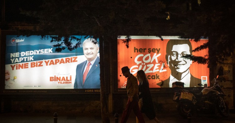  People walk past election posters of AK Parti candidate Binali Yildirim (L) and CHP Party, candidate Ekrem Imamoglu (R) during campaigning in the re-run of the Istanbul mayoral election on June 01, 2019 in Istanbul, Turkey. 