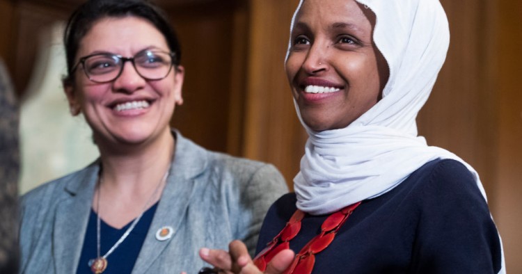 Reps. Ilhan Omar, D-Minn., right, and Rashida Tlaib, D-Mich., attend a rally with Democrats in the Capitol to introduce the "Equality Act," which will amend existing civil rights legislation to bar discrimination based on gender identification and sexual orientation on Wednesday, March 13, 2019. 