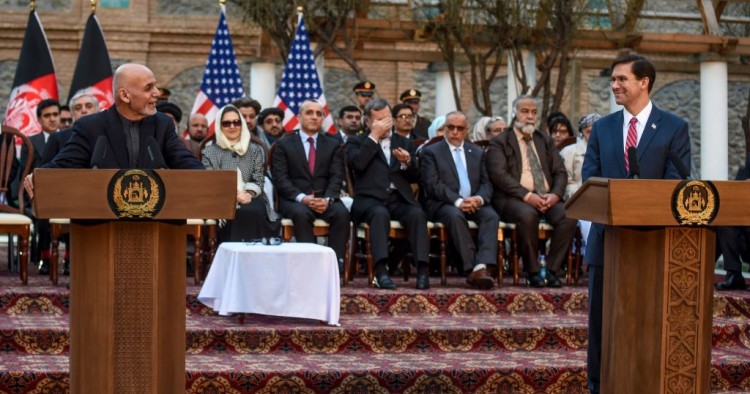 Afghanistan's President Ashraf Ghani (L) speaks as US Secretary of Defense Mark Esper (R) listens during a press conference at the presidential palace in Kabul on February 29, 2020. - The United States signed a landmark deal with the Taliban on February 29, laying out a timetable for a full troop withdrawal from Afghanistan within 14 months as it seeks an exit from its longest-ever war. (Photo by WAKIL KOHSAR / AFP)