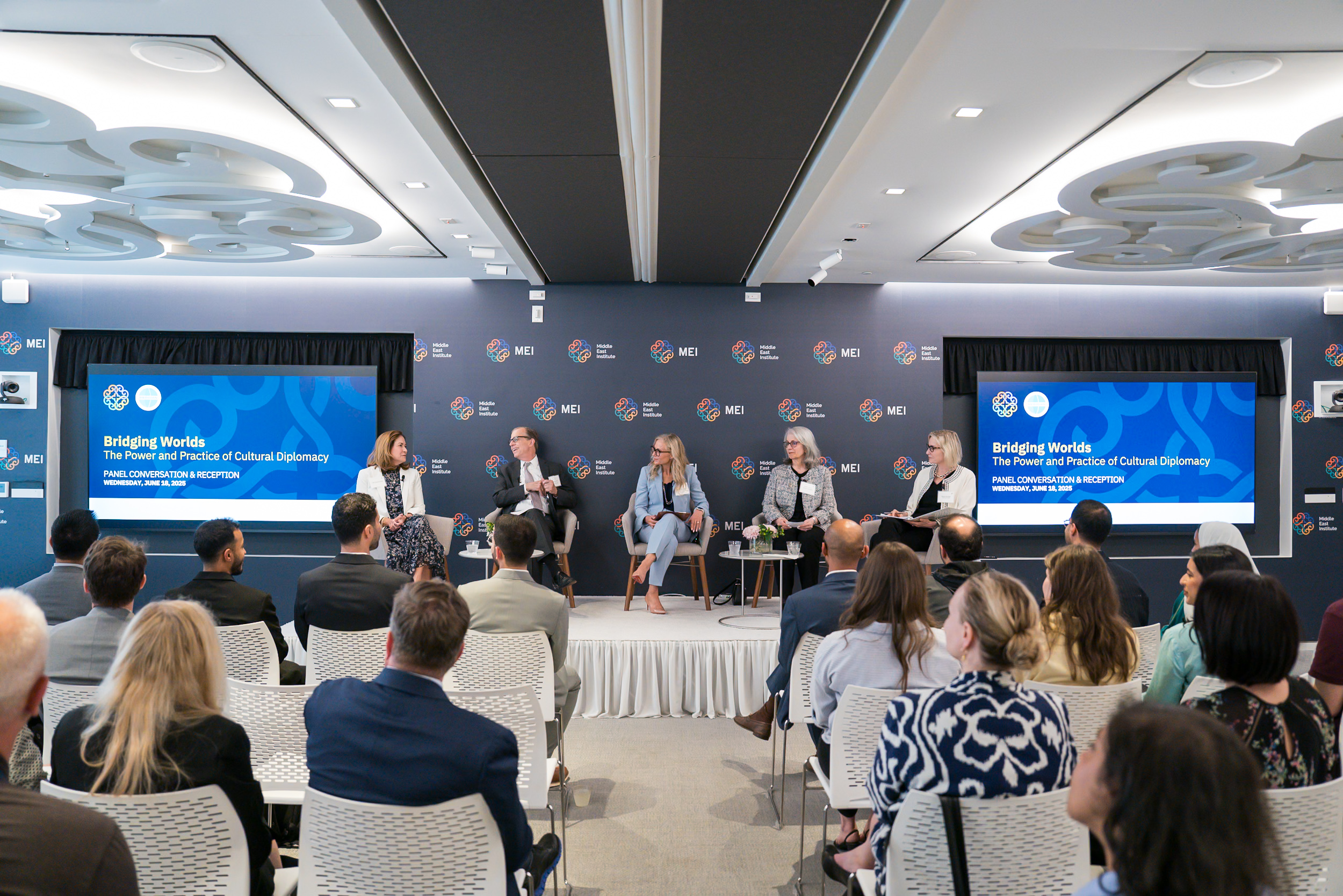 Image showing the panelists on the stage at MEI.
