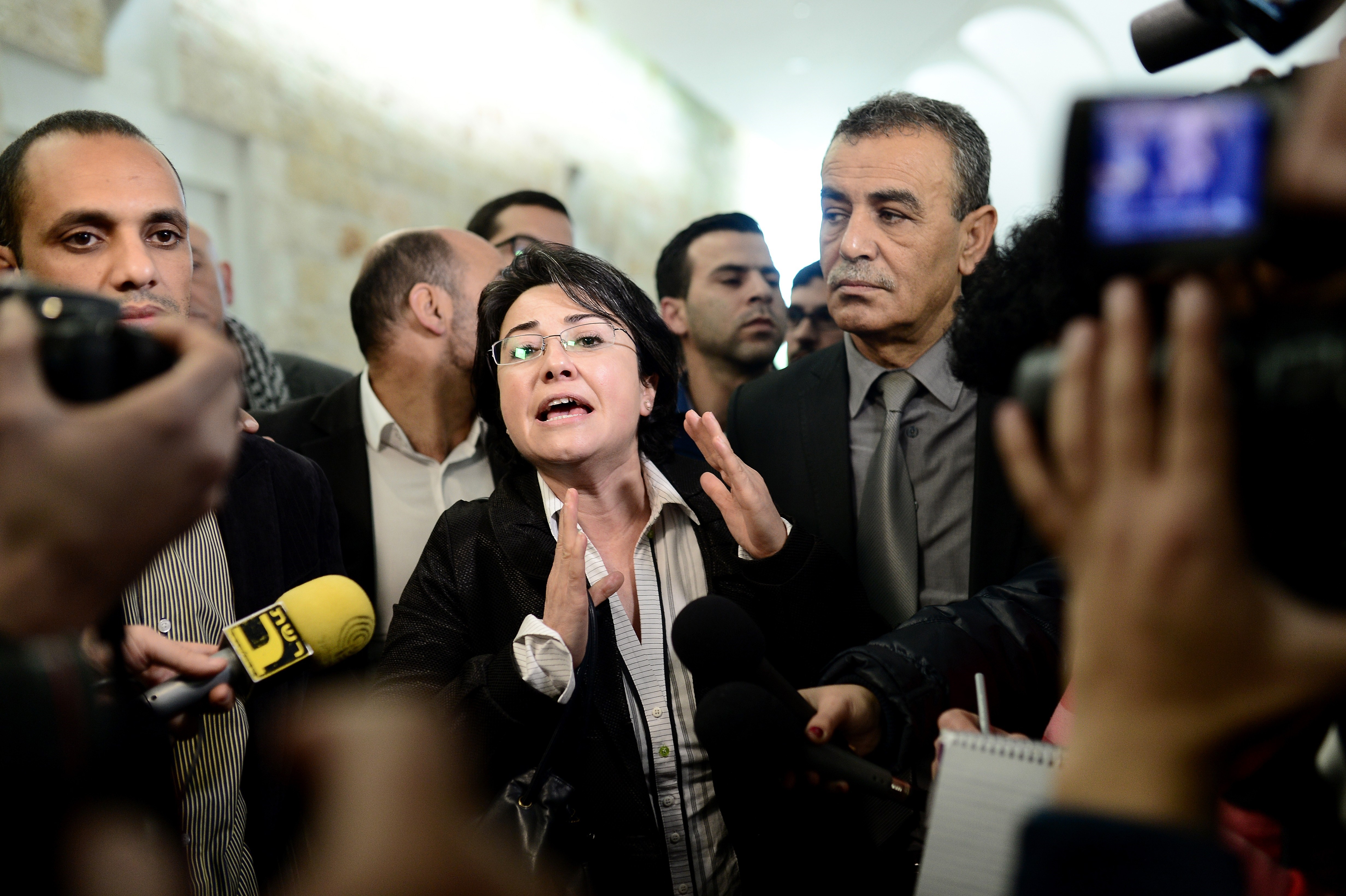 Arab member of Israel's Knesset Haneen Zoabi (C) speaks to the press after the court decision about Israels ban of Arab lawmaker Zoabi from election in Jerusalem on February 14, 2015.