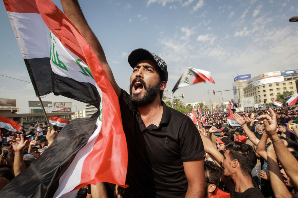 Protesters shout slogans during an anti-government demonstration about the provision of jobs and alleged government corruption, in Tahrir Square in central Baghdad, October 1, 2019 (Photo by Ameer Al Mohammedaw/picture alliance via Getty Images)