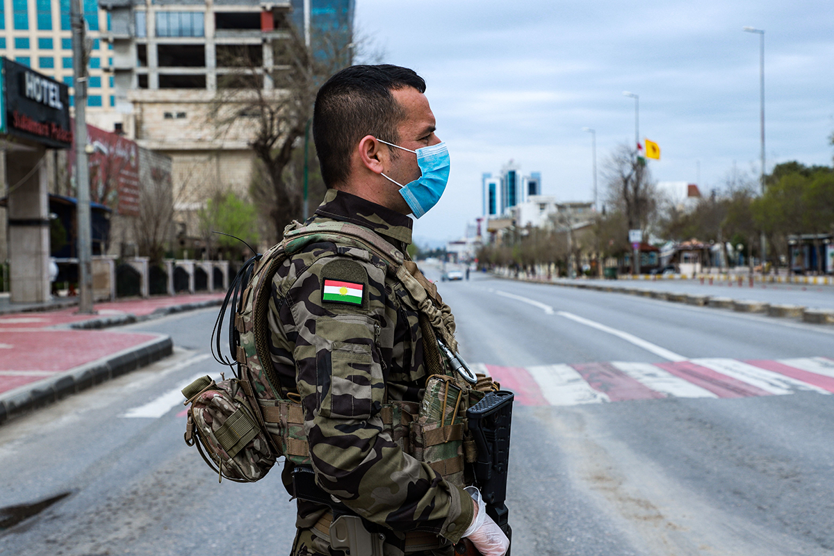 A member of the Iraqi Kurdish Asayish security organization at a security checkpoint in the city of Sulaimaniyah, on March 14, 2020. Photo by SHWAN MOHAMMED/AFP via Getty Images.