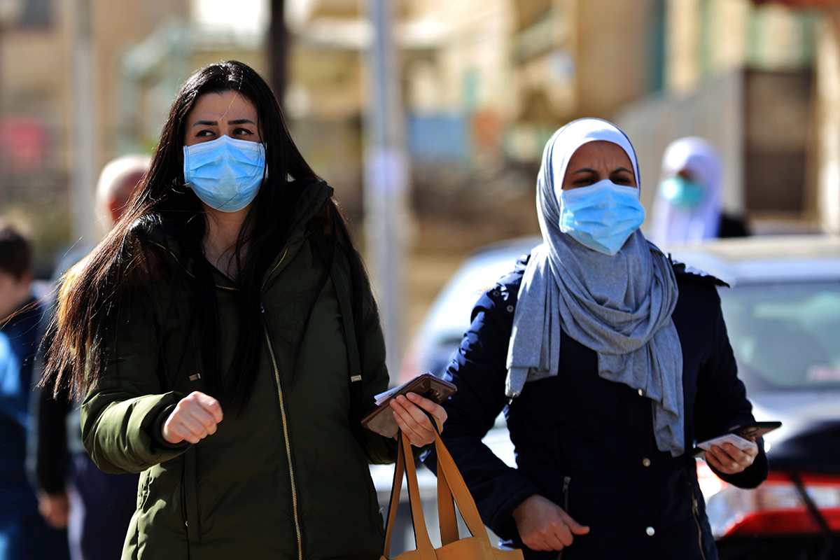 Women wearing face masks walk on a street in Amman, Jordan, on March 24, 2020. Photo by Mohammad Abu Ghosh/Xinhua via Getty Images.