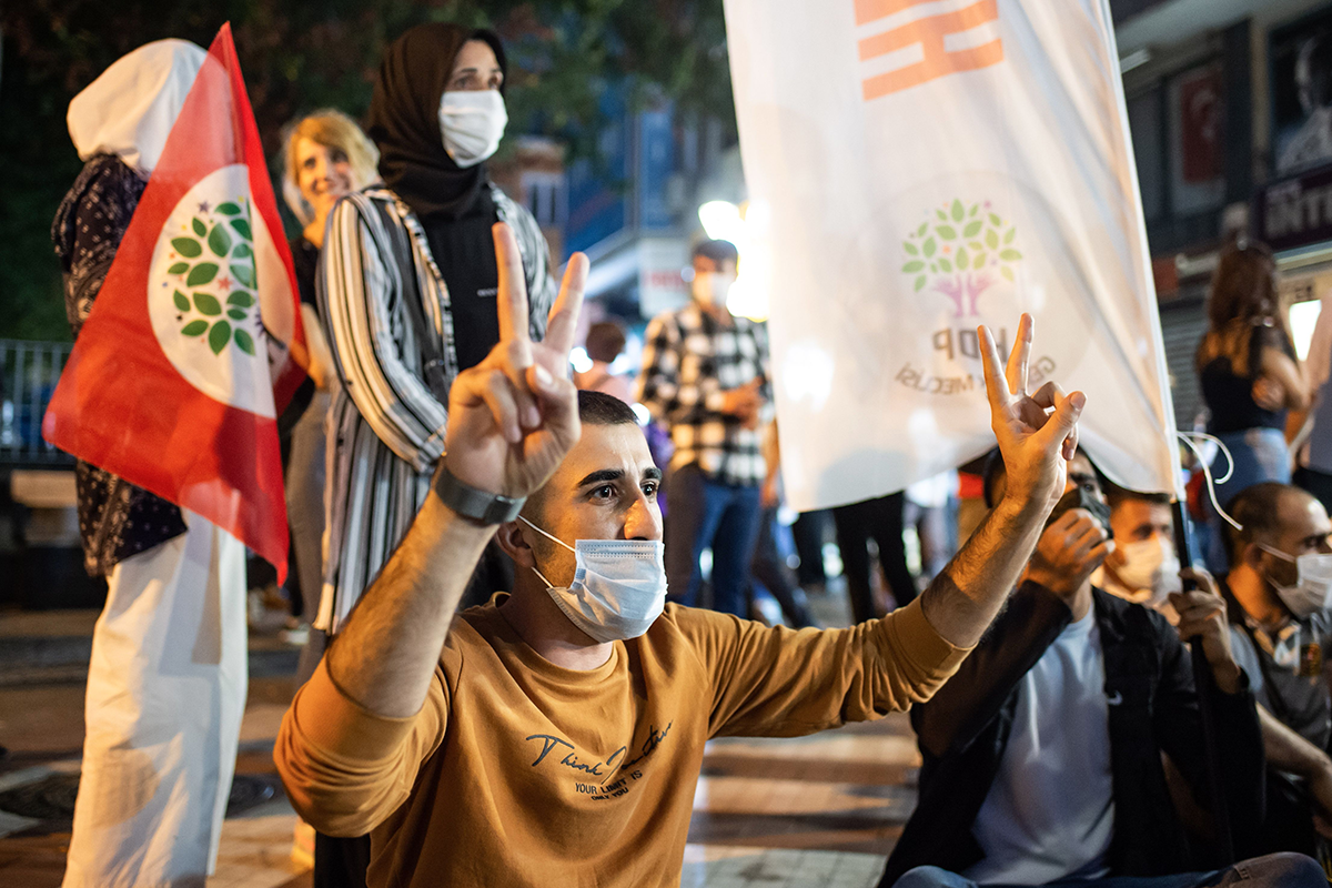 A man flashes a “V” sign as members of the pro-Kurdish Peoples’ Democratic Party (HDP) take part in a protest against the detention of HDP members, in Istanbul, on September 25, 2020. Photo by YASIN AKGUL/AFP via Getty Images.
