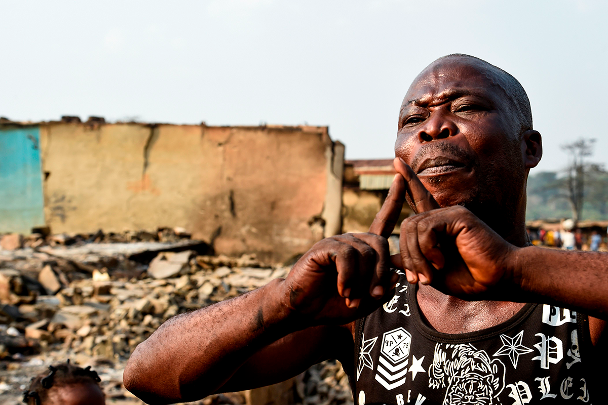 Photo above: Prince Adelabu Abiodun, a victim of the deadly ethnic clashes between the northern Fulani and southern Yoruba traders, speaks of burnt valuables at Shasha Market in Ibadan, southwest Nigeria, on Feb. 15, 2021. Photo by PIUS UTOMI EKPEI/AFP via Getty Images.