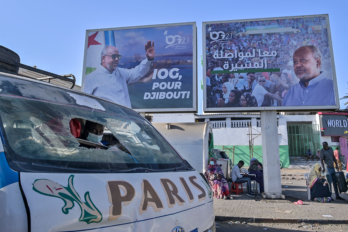 A giant campaign banner advertising the candidacy of Djibouti President Ismael Omar Guelleh overlooks the busy main market on the eve of national elections in the capital Djibouti on April 8, 2021. (Photo by TONY KARUMBA/AFP via Getty Images)