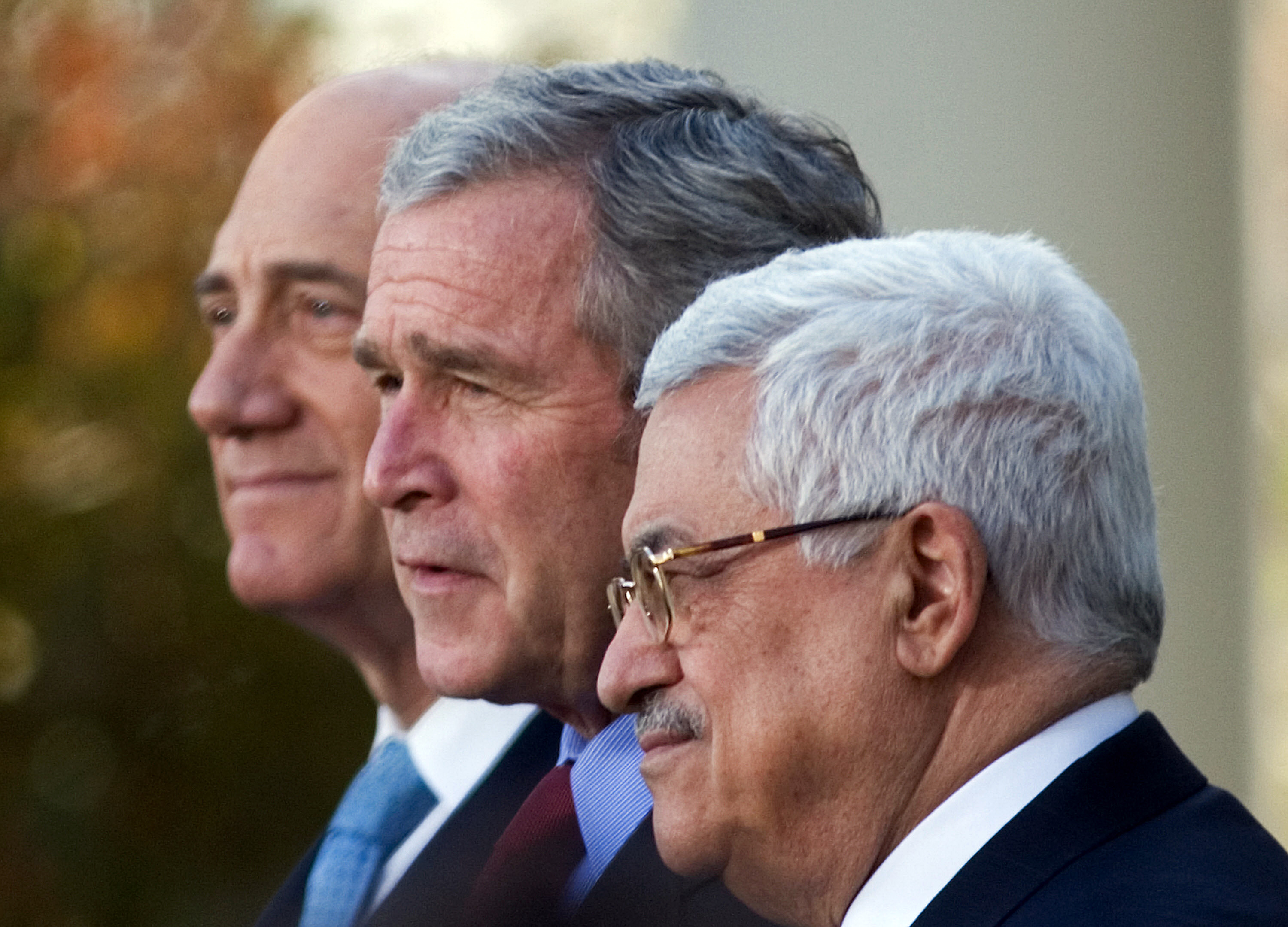 Photo above: U.S. President George W. Bush (C) speaks during a press conference with Israeli Prime Minister Ehud Olmert (L) and Palestinian President Mahmud Abbas on November 28, 2007 at the White House in Washington, D.C. Photo by MANDEL NGAN/AFP via Getty Images.