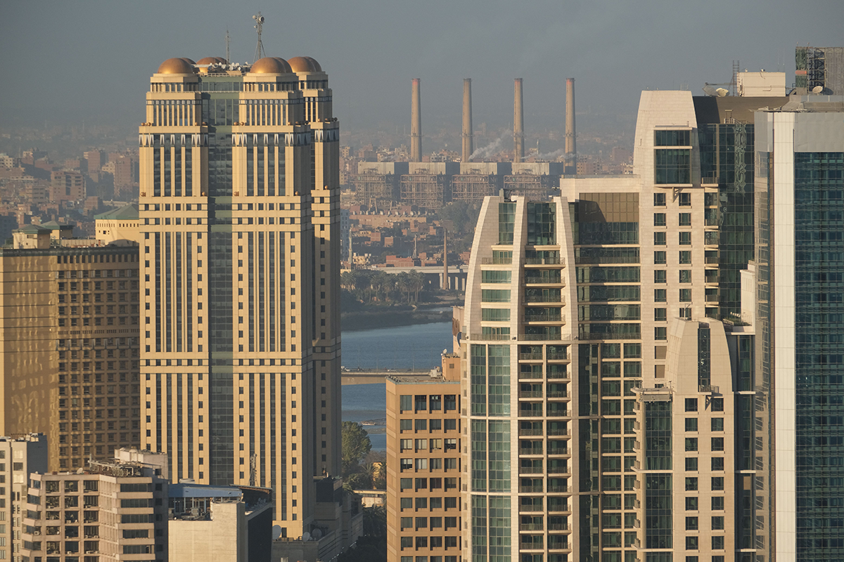 Photo above: A view of the Shubra al-Kheima natural gas electrical power station in the background behind high-rise skyscrapers along the Nile River in Cairo on Jan. 13, 2022. Photo by AMIR MAKAR/AFP via Getty Images.