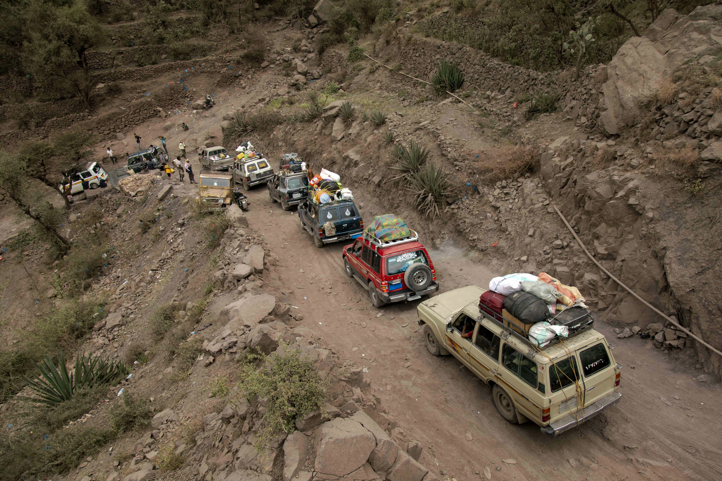 Photo above: Traffic on a heavily damaged narrow road that serves as a lifeline between Taiz, besieged by the Houthis, and the southern port of Aden, on July 8, 2022. Photo by AHMAD AL-BASHA/AFP via Getty Images.