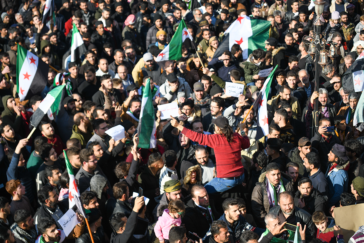 Photo above: Demonstrators are raising Syrian opposition flags and placards as they rally against a potential rapprochement between Ankara and the Syrian regime in the opposition-held city of Azaz, on the border with Turkey in Syria’s northern Aleppo province, on Dec. 30, 2022. Photo by Rami Alsayed/NurPhoto via Getty Images.