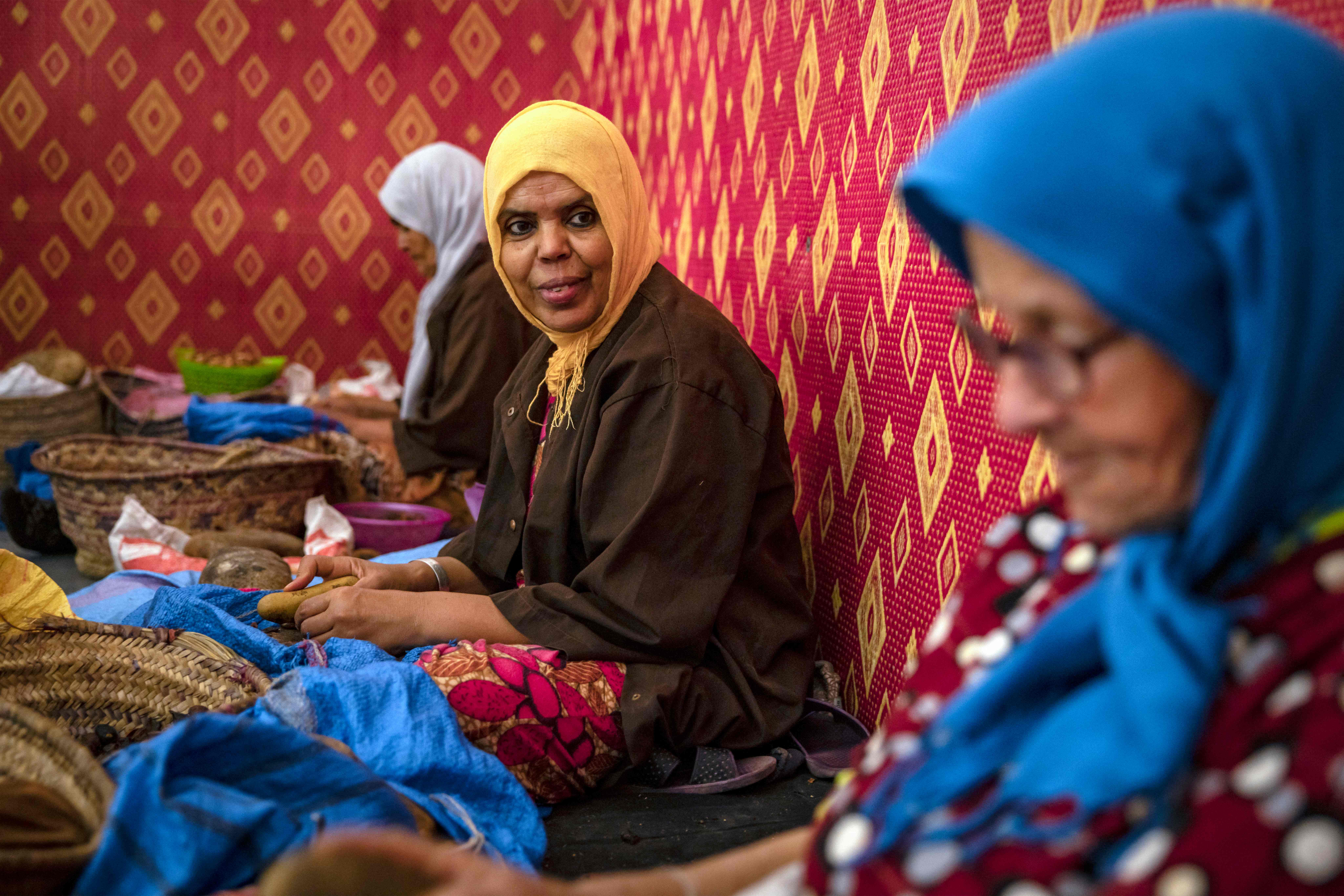 Women shell argan nuts to make oil near Morocco’s western Atlantic coastal city of Essaouira, on October 15, 2022. Photo by FADEL SENNA/AFP via Getty Images.