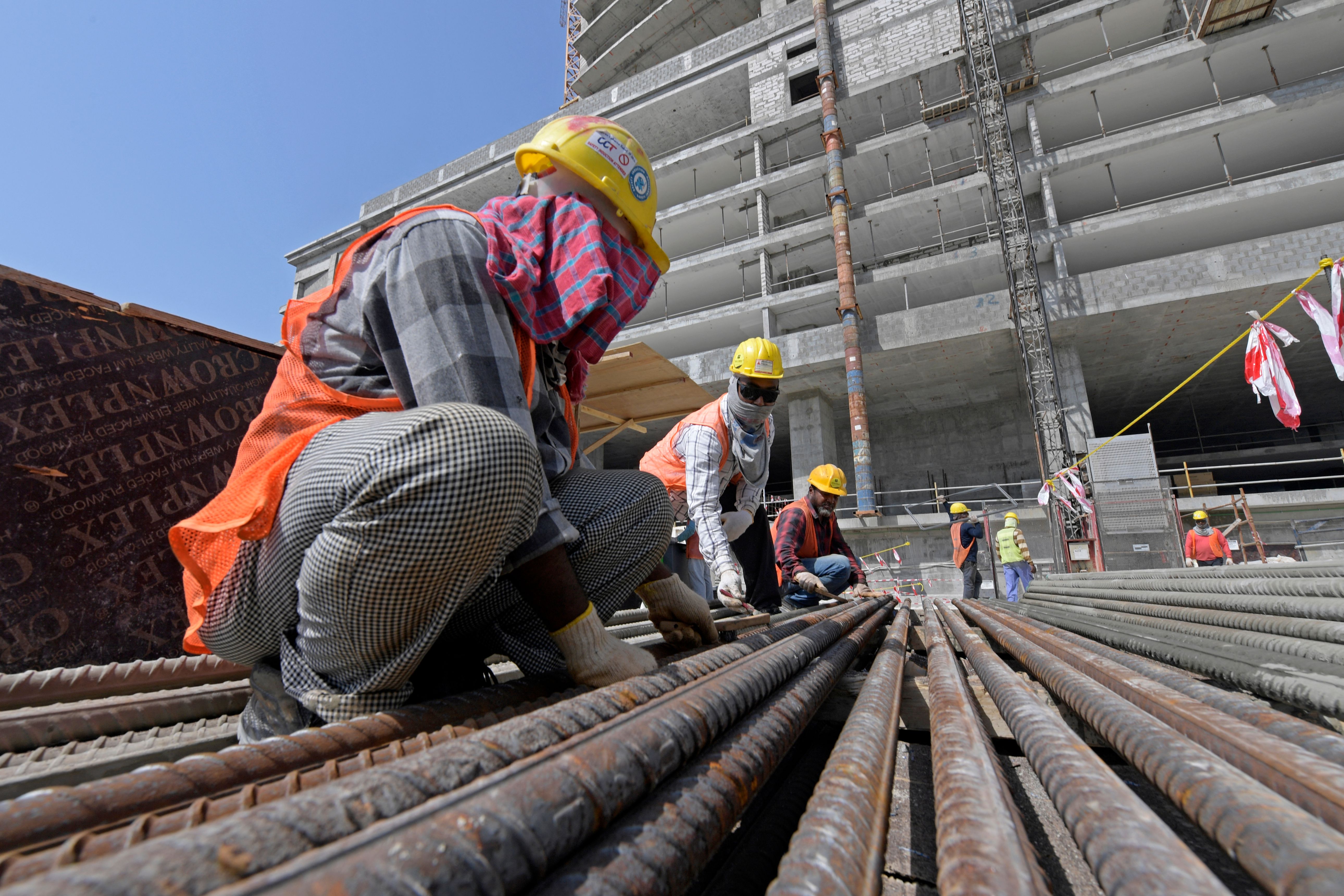 Workers work on the construction site of the Golden Gate towers at Bahrain Bay in Manama on March 25, 2023. Photo by MAZEN MAHDI/AFP via Getty Images.