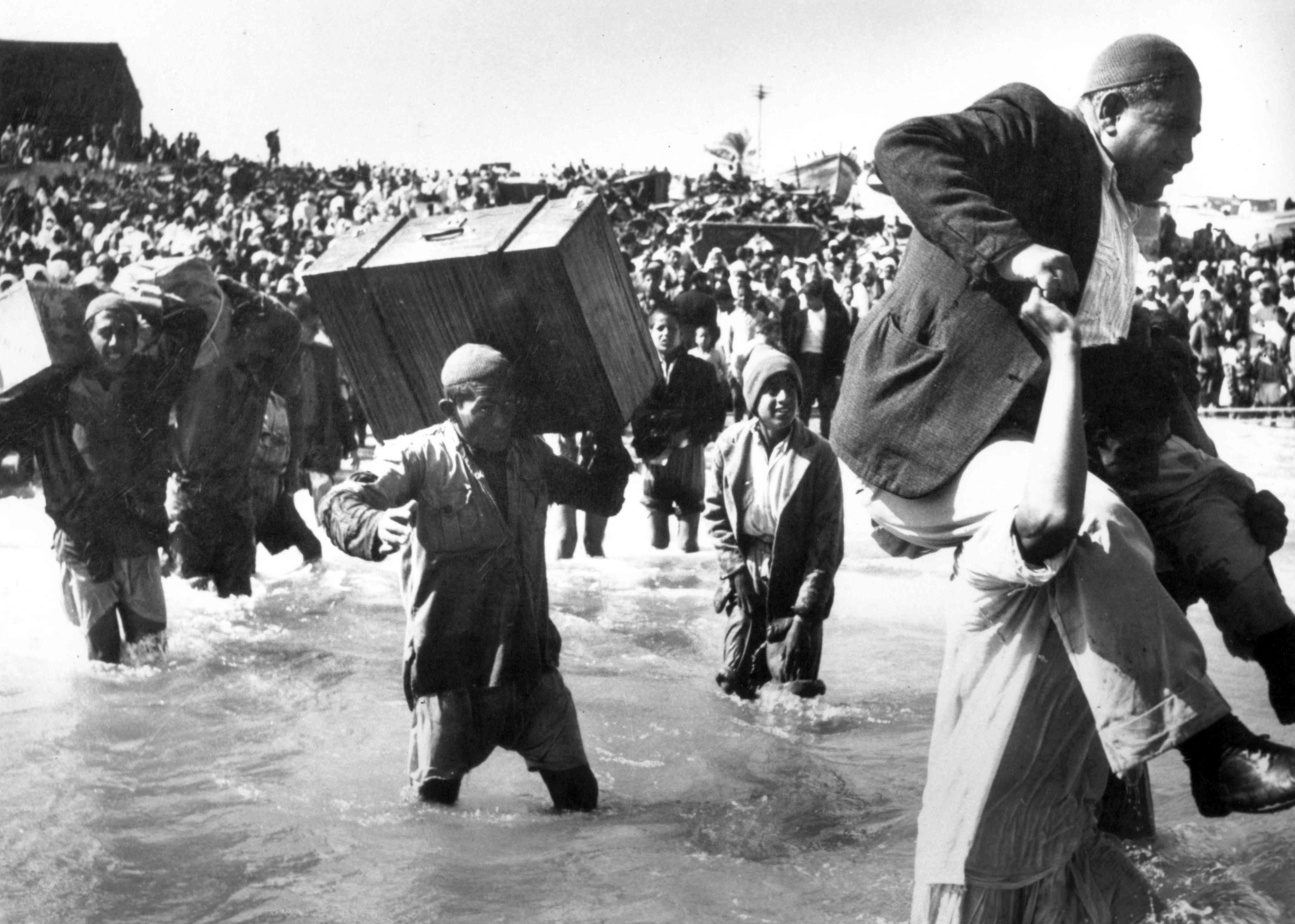 Photo above: Palestinians driven from their homes by Israeli forces and fleeing via the sea at Acre, 1948. Photo by Pictures From History/Universal Images Group via Getty Images.