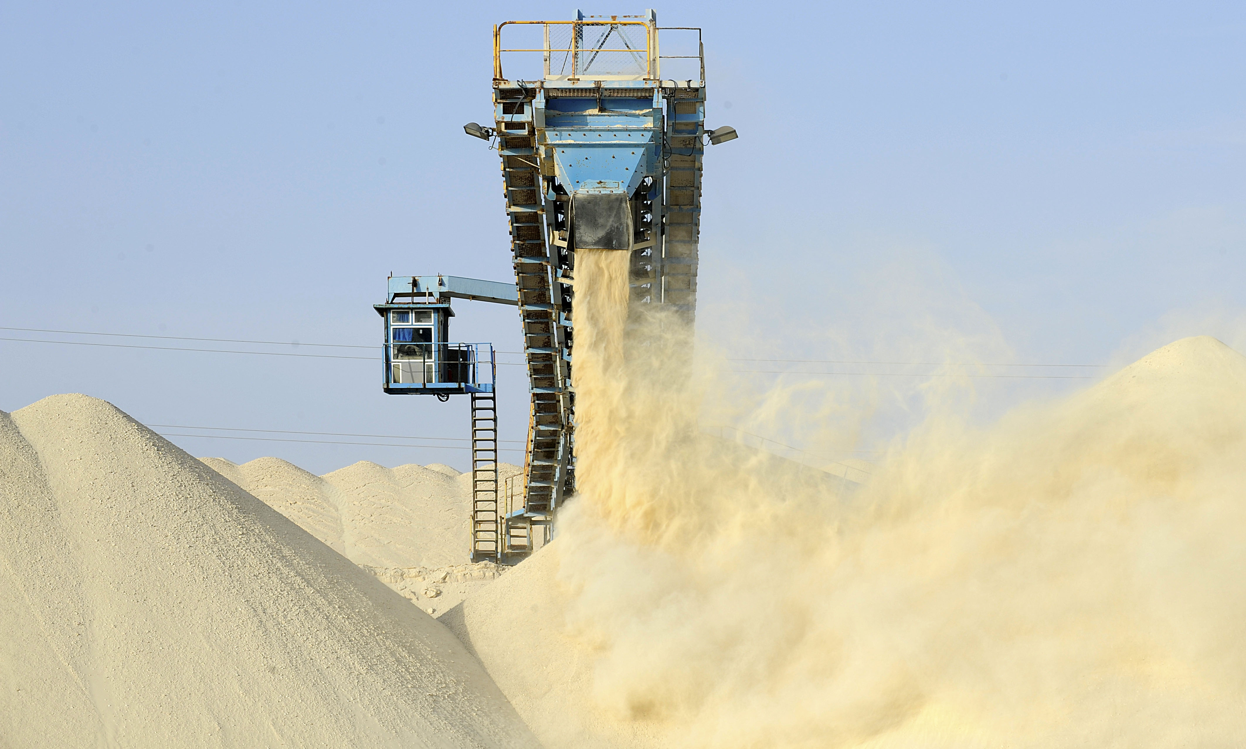 Untreated phosphate being dropped off at the end of a conveyor belt at OCP’s Marca factory near Laayoune, the capital of Moroccan-controlled Western Sahara, on May 13, 2013. Photo by FADEL SENNA/AFP via Getty Images.