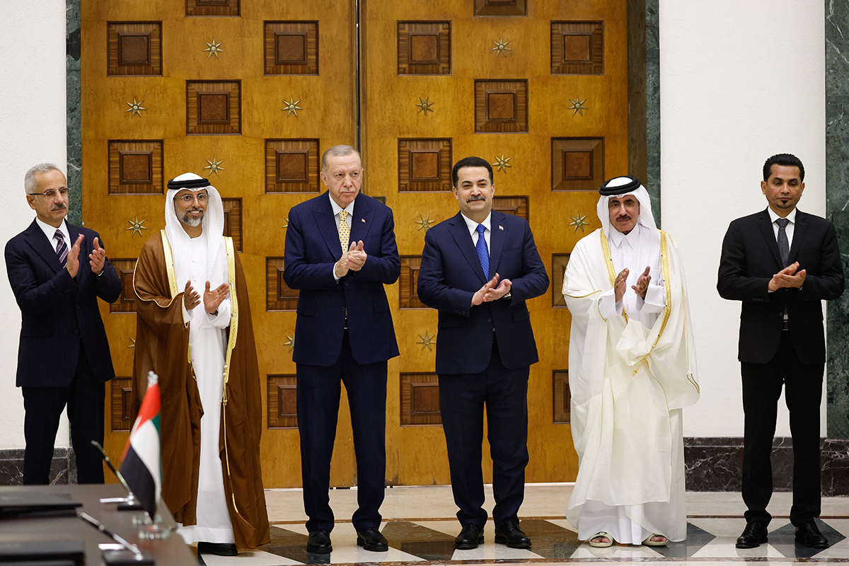 Turkish, Emirati, Iraqi, and Qatari officials applaud during their meeting for the signing of the "Development Road" framework agreement on security, economy, and development in Baghdad on April 22, 2024. Photo by THAIER AL-SUDANI/POOL/AFP via Getty Images.