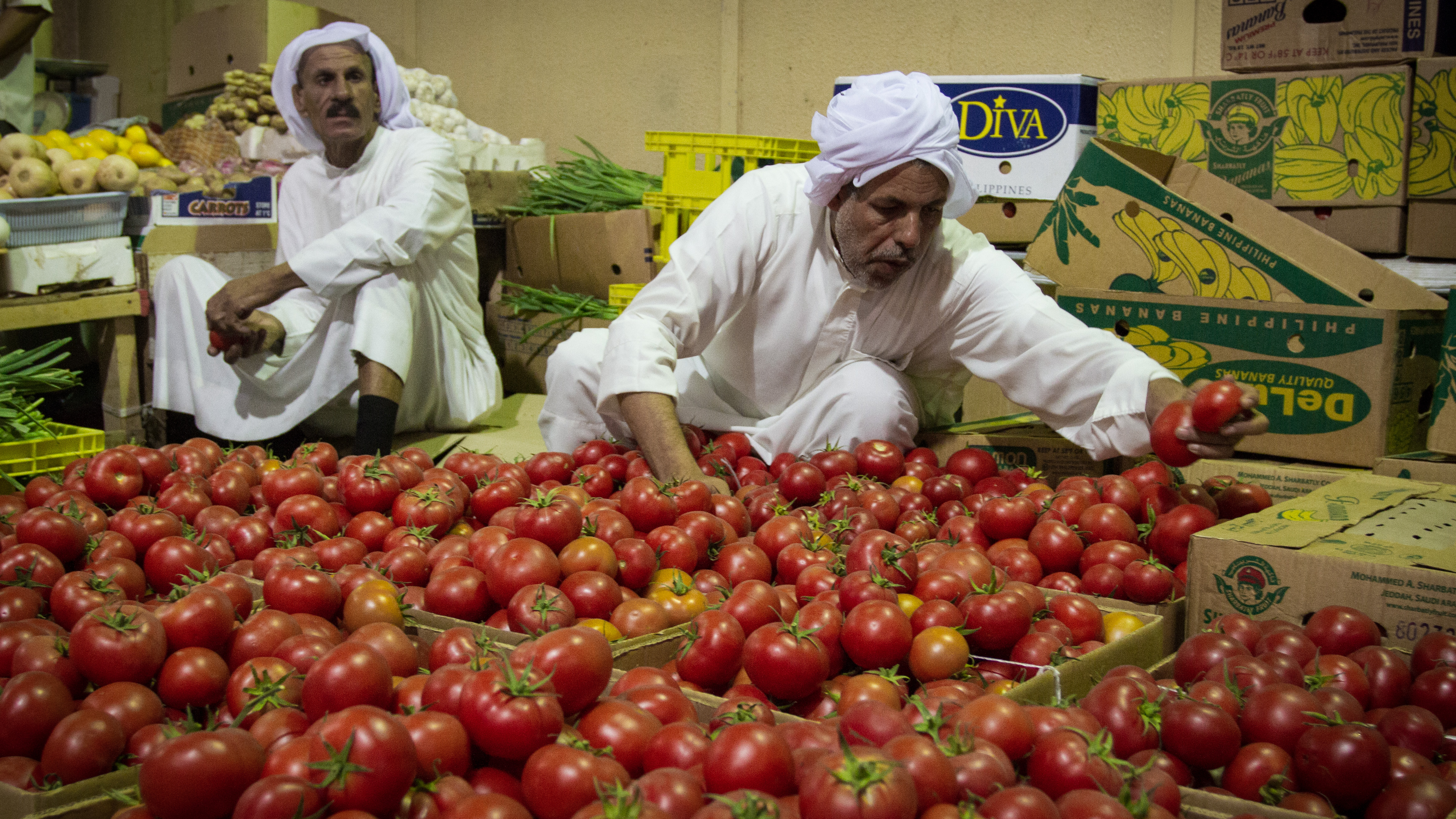 A Bahraini vendor sells his farm crop of tomatoes in the central market in Bahrain. Photo by Hussain Albahrani/Pacific Press/ LightRocket via Getty Images.