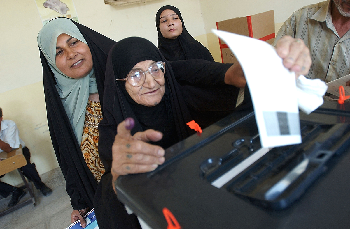 An Iraqi woman votes in a constitutional referendum on October 15, 2005 in the city of Basra. (Photo by Wathiq Khuzaie /Getty Images)
