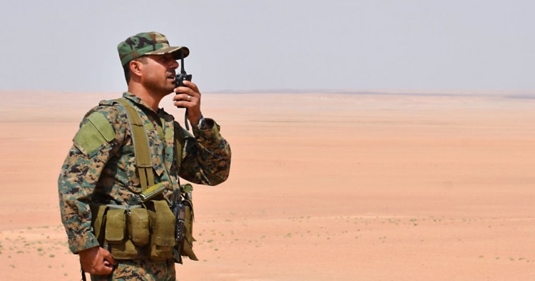 Photo above: A member of the Syrian government forces talks on a walkie-talkie in Bir Qabaqib, more than 40 km west of Deir ez-Zor, after taking control of the area on their way to Kobajjep in the ongoing battle against Islamic State group jihadists on September 4, 2017. Photo by GEORGE OURFALIAN/AFP via Getty Images.