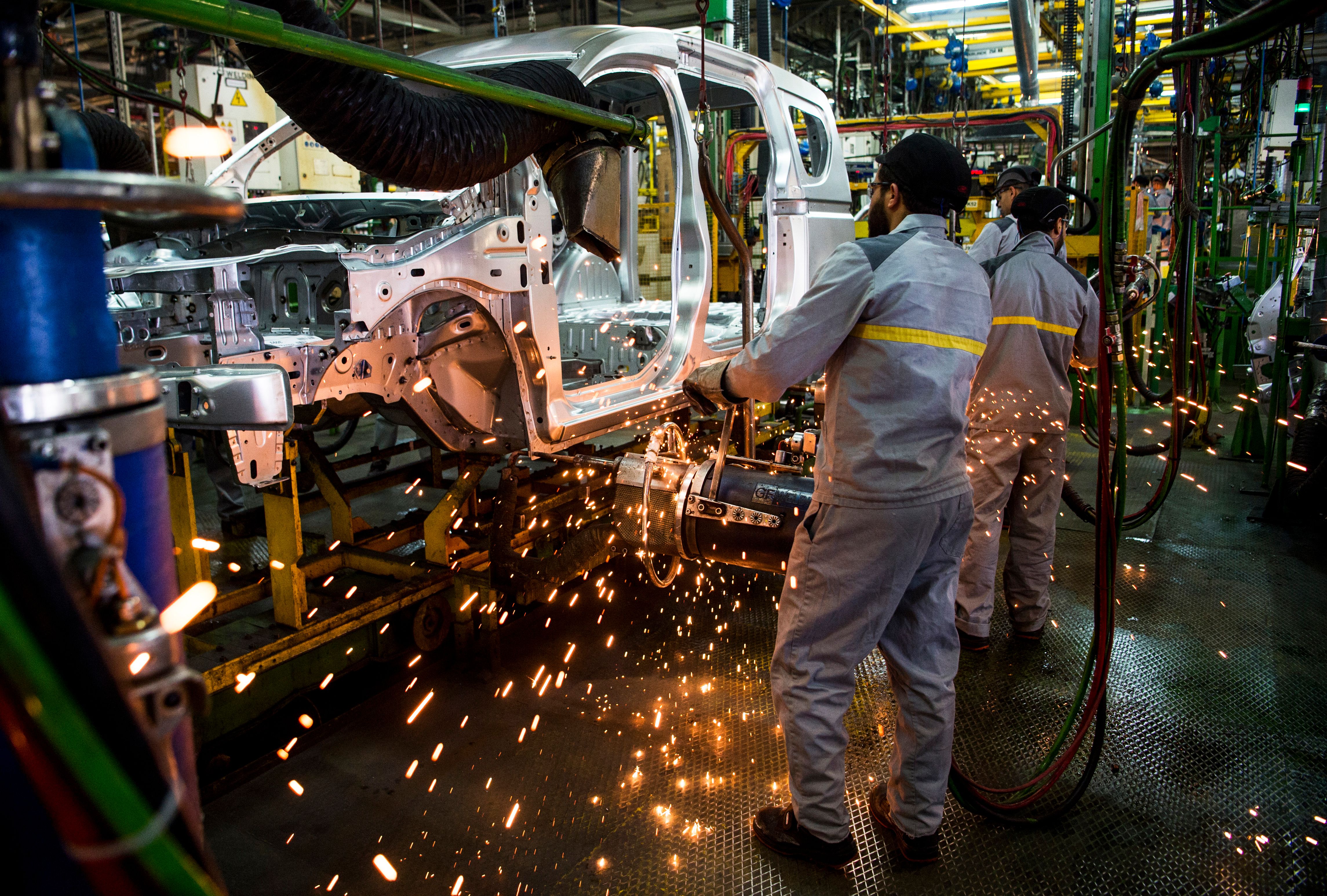 Factory employees work on a car assembly line at the Renault-Nissan Tangier Car Assembly Plant in Melloussa, Morocco, east of the port city of Tangiers, on March 12, 2018. Photo by FADEL SENNA/AFP via Getty Images.