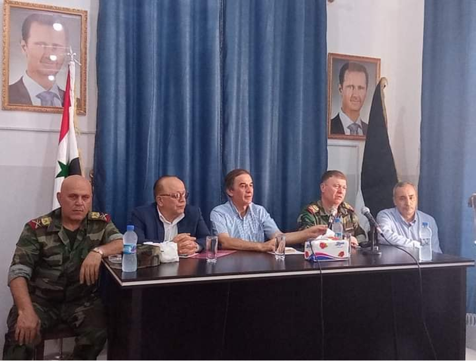 Hussam Luka (center) with Maj. Gen. Ali Mahmoud (second from right) at the opening of the Khan Sheikhoun taswiya center.