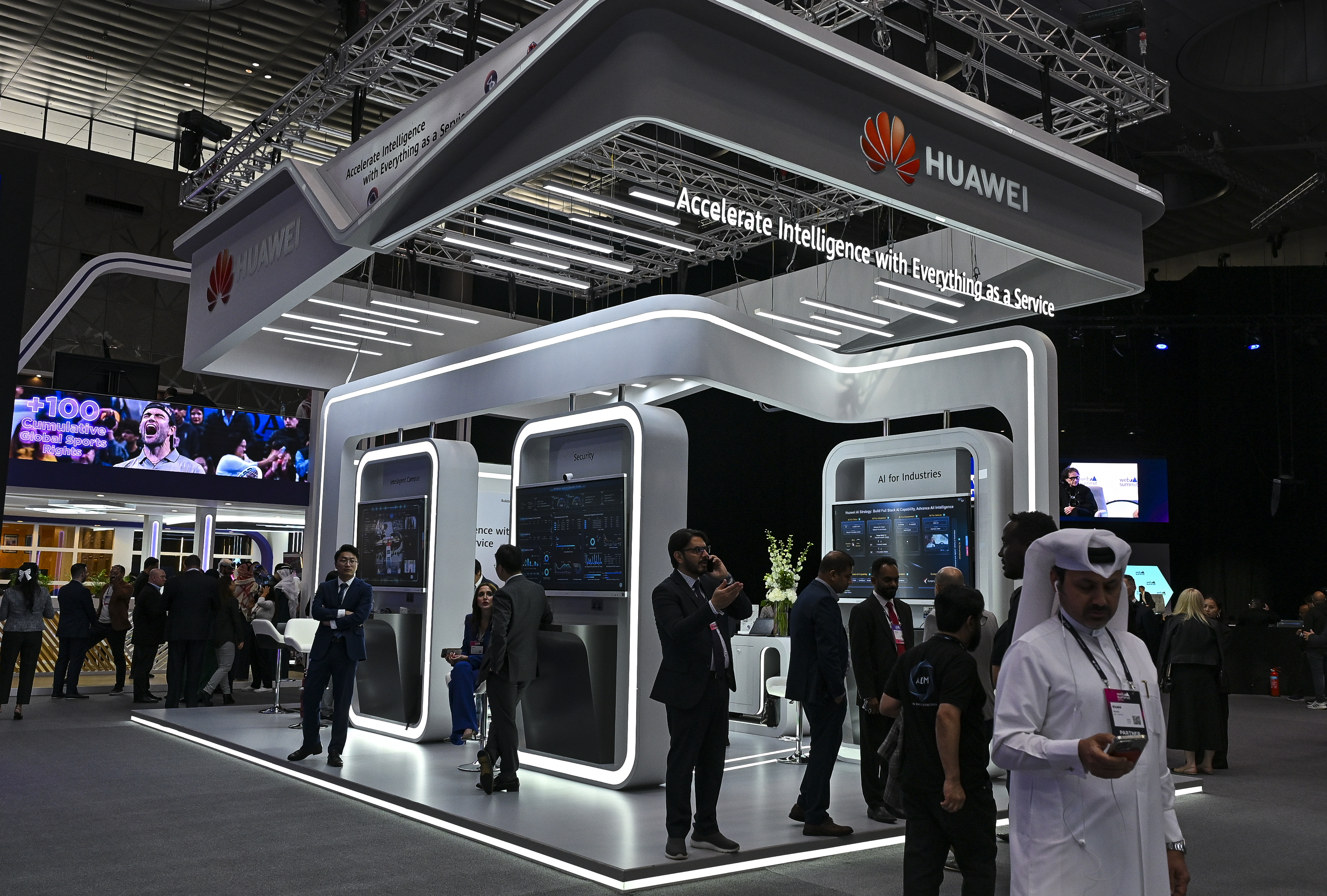 Photo above: People walk past a Huawei stand during the third day of the Web Summit in Doha, Qatar, on February 25, 2025. Photo by Noushad Thekkayil/NurPhoto via Getty Images.[/caption]