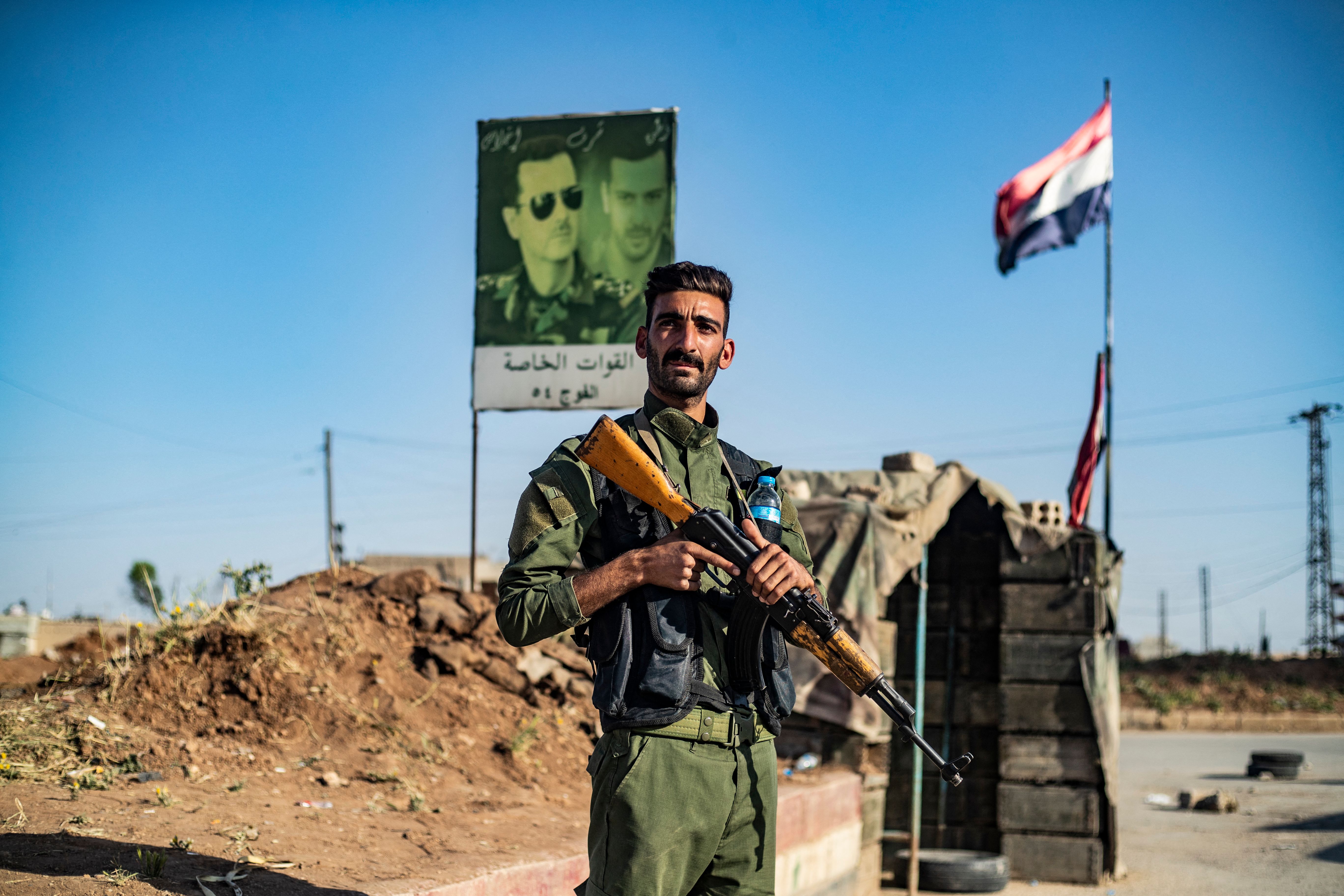 Photo above: A member of the Syrian Kurdish internal security services known as “Asayish” stands at a checkpoint in Qamishli, Syria. Photo by Delil Souleiman/AFP via Getty Images.