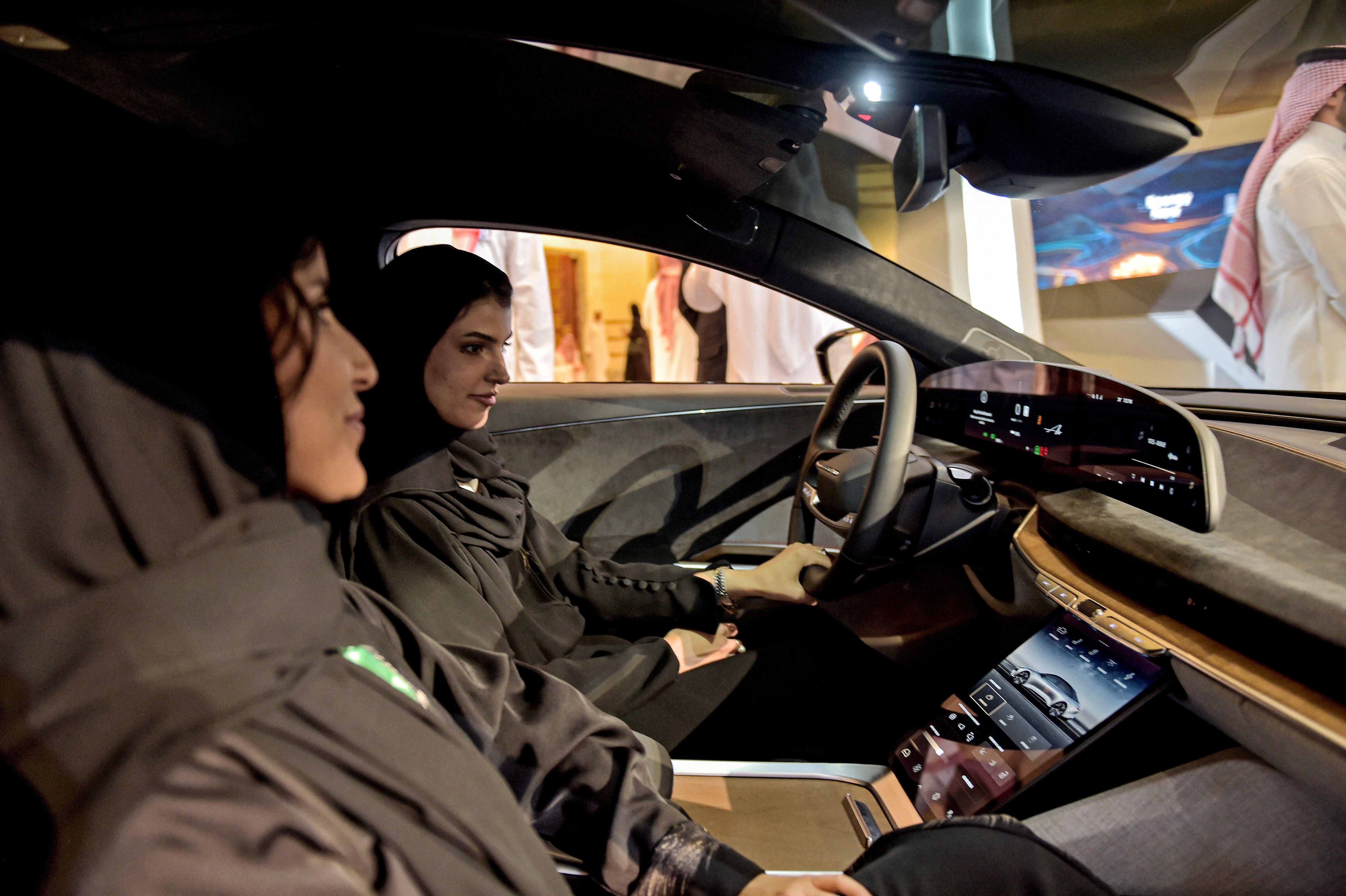 Saudi women in electric vehicle manufactured by US automaker Lucid Group. Photo by Amer Hilabi/AFP via Getty Images.