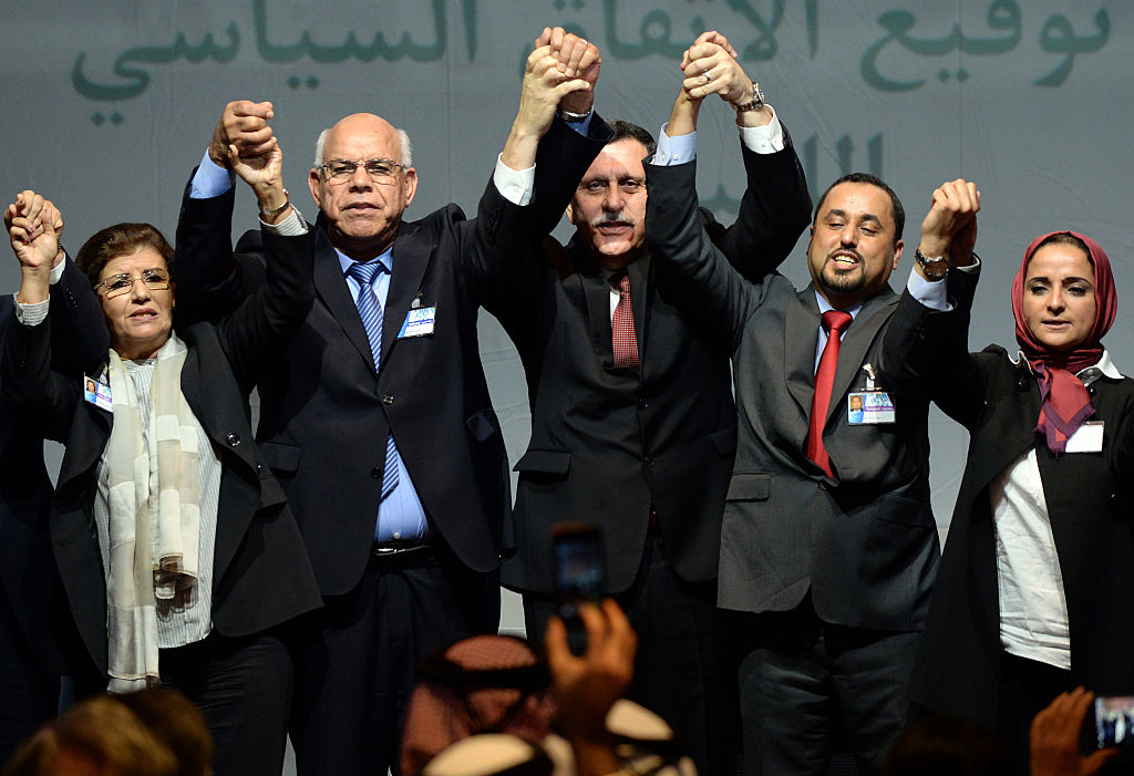 Libya's General National Congress (GNC) deputy president Saleh al-Makhzoum (2ndR), the new national government head, Prime Minister, Fayez al-Sarraj (C) and the head of the Tobruk-based House of Representatives Mohammed Ali Shoeb (2ndL) celebrate after signing a deal on a unity government on December 17, 2015, in the Moroccan city of Skhirat. 