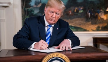 President Donald J. Trump signs a National Security Presidential Memorandum as he announces the withdrawal of the United States from the Iran nuclear deal during a 'Joint Comprehensive Plan of Action' event in the Diplomatic Reception Room of the White House on Tuesday, May 08, 2018 in Washington, DC.