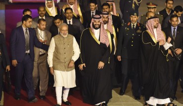 Saudi Crown Prince Mohammed bin Salman walks next to Indian Prime Minister Narendra Modi upon arriving at the airport in New Delhi on February 19, 2019.