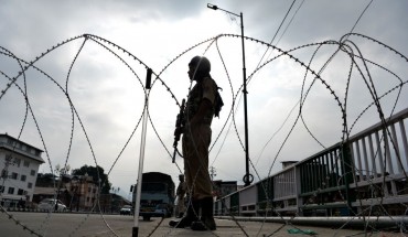 A security personnel stands guard on a street during a lockdown in Srinagar on August 11, 2019, after the Indian government stripped Jammu and Kashmir of its autonomy.