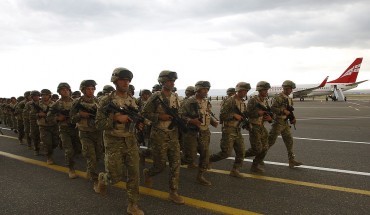 Georgian soldiers run during a farewell ceremony before their departure to Afghanistan in Tbilisi, June 27, 2013. 