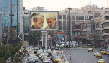 A billboard bearing a portrait with the black mourning ribbon of slain Iranian military commander Qasem Soleimani (L) and Iraqi paramilitary chief Abu Mahdi al-Muhandis hangs on a main road in the Iranian capital Tehran on January 4, 2020, one day after Soleimani and other members of the pro-Iranian Iraqi paramilitary group Al-Hashed Al-Shaabi were killed in a US air strike near Baghdad international airport. 