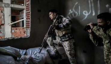  Fighters of the UN-backed Government of National Accord take cover during clashes with Libyan National Army forces at Al-Nahr frontline in Tripoli, Libya, on March 8, 2020. 