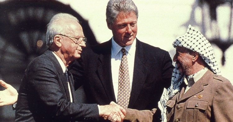 Clinton observing handshake
