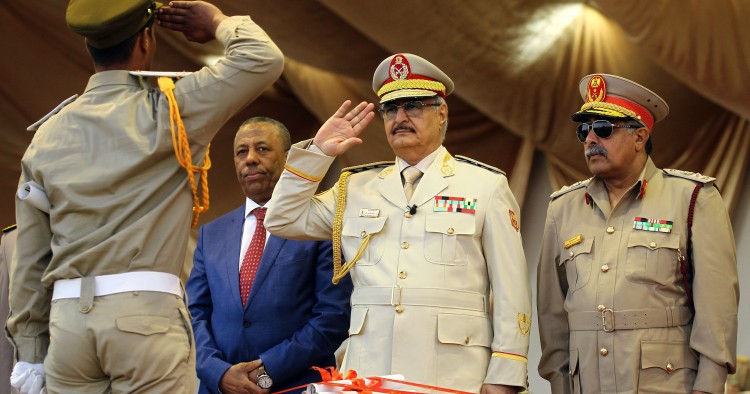 Libyan Strongman Khalifa Haftar salutes next to Libyan National Army's Chief Of Staff Abdelrazak al-Nadhuri and Libyan former prime minister Abdullah al-Thani.