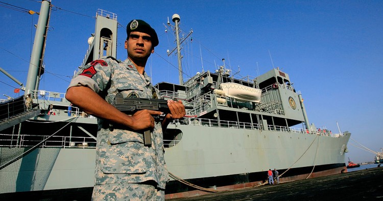 An Iranian navy special forces known as Takavaran wearing a similar uniform worn by the US military and holding an Israeli made Uzi sub-machine gun stands guard near the Iranian Kharg replenishment ship docked in the Red Sea Sudanese town of Port Sudan on October 31, 2012. 