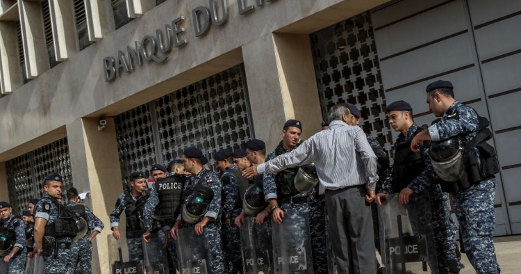 A demonstrator argues with riot police guarding the entrance of the Lebanese Central Bank during a protest by retired Lebanese army and security personnel as part of a preemptive strike against austerity measures in the 2019 draft state budget that might affect their retirement wages. 