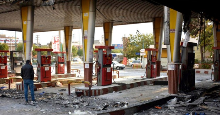 An Iranian man checks a scorched gas station that was set ablaze by protesters during a demonstration against a rise in gasoline prices in Eslamshahr, near the Iranian capital of Tehran, on November 17, 2019. 