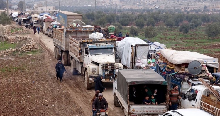Syrian families, who have been forced to displace due to the ongoing attacks carried out by Assad regime and Russia, are seen on their way to safer zones with their belongings, at Atme camps in Idlib, Syria on January 19, 2020. 