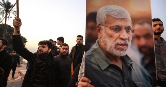 Supporters of the predominantly Shia Muslim Popular Mobilization Forces (PMF) gather with flags and posters of the PMF deputy head Abu Mahdi al-Muhandis during an anti-US protest after the US airstrike in Baghdad