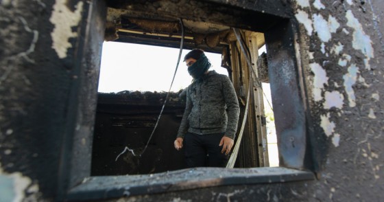  A protester stands inside a burned checkpoint during the sit-in against deadly US airstrikes on sites of a Shiite militia in front of the US embassy. Iraqi mourners on Tuesday stormed the building of the US embassy in Baghdad's heavily fortified Green Zone.