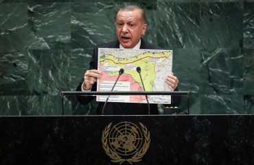 President of Turkey Recep Tayyip Erdogan holds up a map of the safe zone Turkey in in favor of while speaking to the United Nations General Assembly at UN headquarters on September 24, 2019 in New York City. 