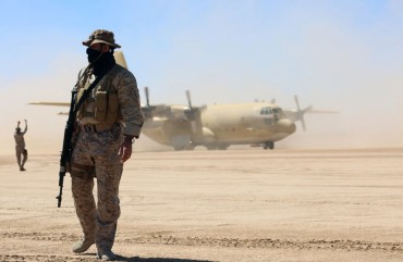 Saudi soldiers stand guard as a Saudi air force cargo plane, carrying aid, lands at an airfield in Yemen's central province of Marib, on February 8, 2018.