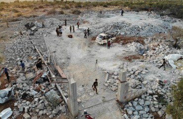 An aerial view taken on October 27, 2019 shows the site that was hit by helicopter gunfire which reportedly killed nine people near the northwestern Syrian village of Barisha in the Idlib province along the border with Turkey, where "groups linked to the Islamic State (IS) group" were present, according to a Britain-based war monitor with sources inside Syria. 
