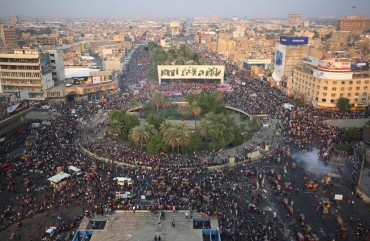 Iraqi demonstrators stand at Tahrir Square in Baghdad during ongoing anti-government demonstrations on October 28, 2019.
