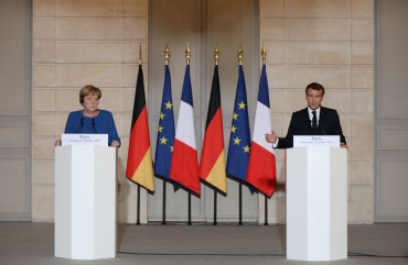 French President Emmanuel Macron (R) and German Chancellor Angela Merkel give a press conference at the Elysee Palace in Paris on October 13, 2019 as they meet for a working dinner ahead of the EU summit. 