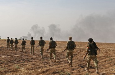 Pro-Turkish Syrian fighters cross the border into Syria as they take part in an offensive against Kurdish-controlled areas in northeastern Syria launched by the Turkish military, on October 11, 2019.